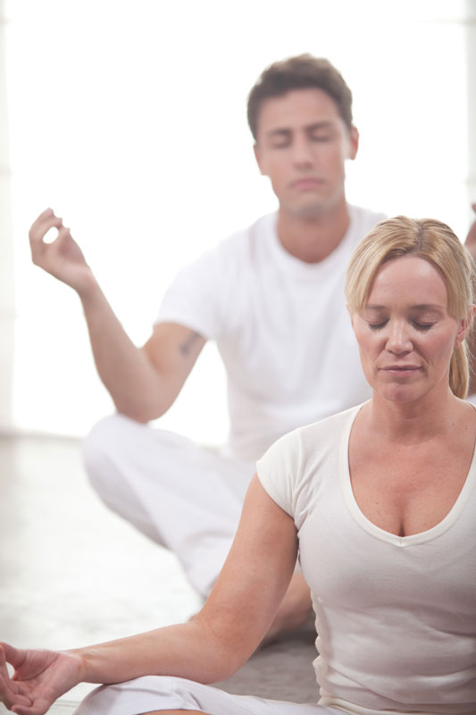 man and woman on floor in meditation